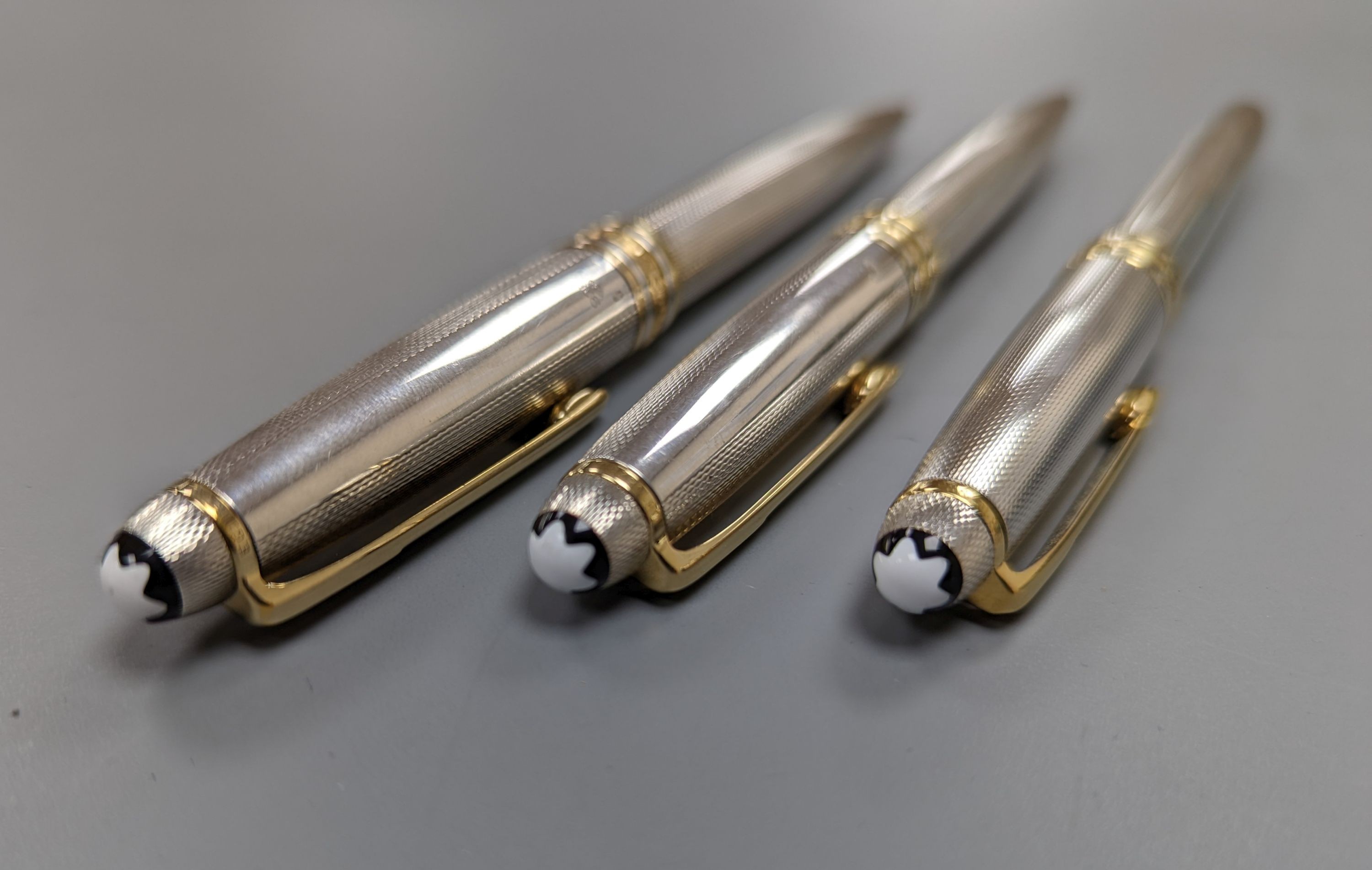 A modern suite of three silver Montblanc Meisterstuck ballpoint pens and pencil